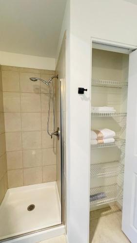 a shower with a glass door in a bathroom at 2B2B apartment with stunning window -7min to Dome in Tacoma