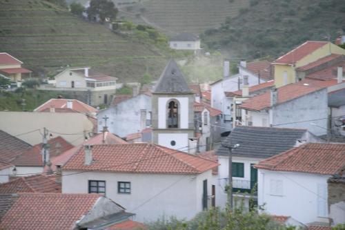 a group of houses and roofs with a church at EiraDouro - Casa Oliveira in Mós