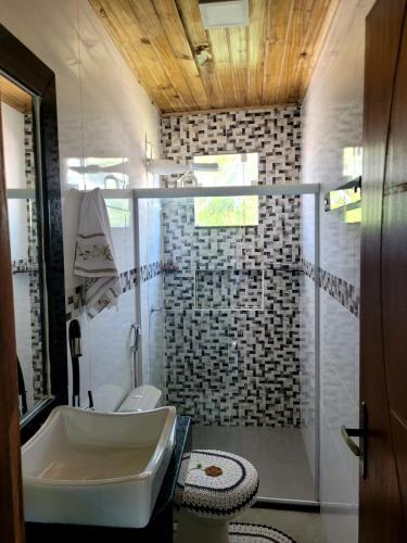a bathroom with a sink and a shower at Vila Mukaú in Porto Seguro