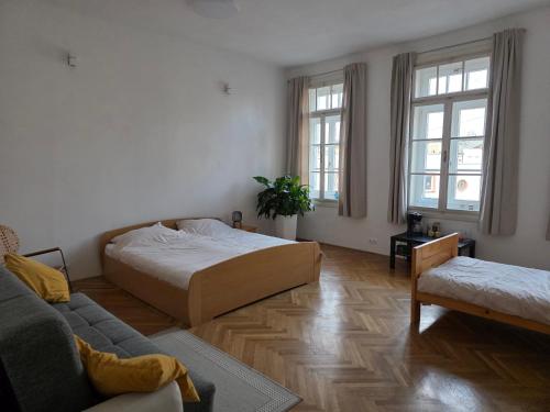 a living room with a bed and a couch at Rooms in Maribor Centre in Maribor