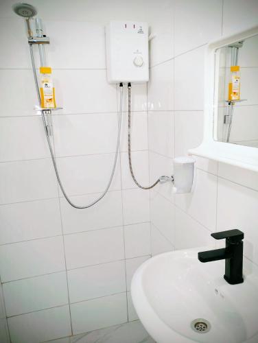a white bathroom with a shower and a sink at GuestHouse 4 Karma369 in Plovdiv