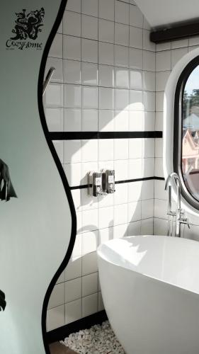 a bathroom with a white sink and a mirror at CozyhomeDaLat in Khu Chi Lăng