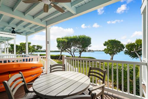 a table and chairs on a porch with a view of the water at 5035 "Villa del Sol"- Amazing Sunset Views! 2bed 3bath in Duck Key