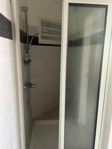 a shower stall with a glass door with a shower at Évasion Soleil in Le Gosier