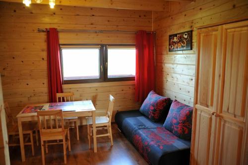 a room with a couch and a table in a cabin at Domki Piękny Widok u Karola in Solina