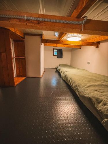 an empty room with two beds in it at Бунгало Борче in Burgas