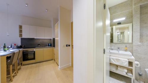 a large kitchen with a sink and a counter at Z terme Harmony in Vrnjačka Banja