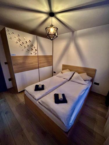 a bedroom with a bed with two towels on it at Bliss Home 2 by RentALL in Gheorgheni