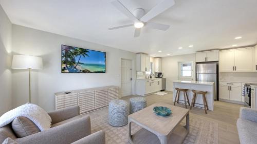 a living room with a couch and a table at Canal 313 - Right in Siesta Key Village! in Siesta Key