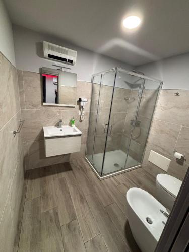 a bathroom with a shower and a sink and a toilet at Fifty shades in Bisaccia