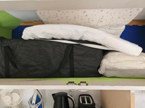 an upper shelf of a bunk bed with white pillows at Little Hill on Sycamore in New Plymouth