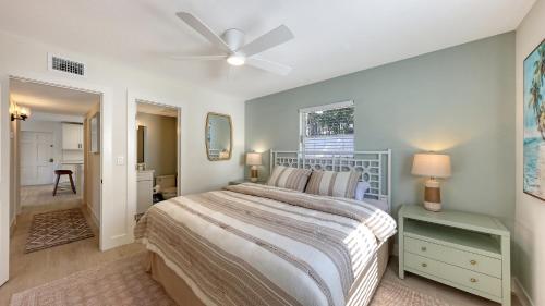 a bedroom with a bed and a ceiling fan at Canal 313 - Right in Siesta Key Village! in Siesta Key