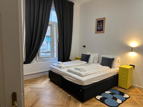 a bedroom with two beds in front of a window at Zest and Nest Apartments in the center in Zagreb