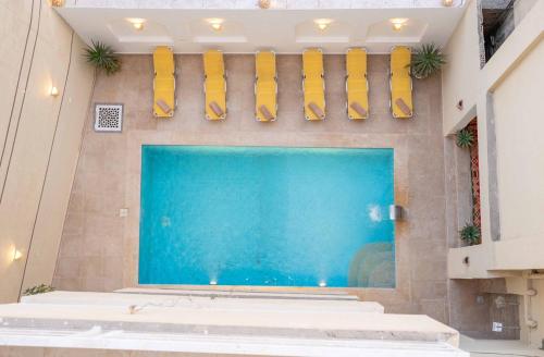 a large swimming pool with yellow fins on a wall at Theban Hills Hotel, Luxor in ‘Ezbet Abu Ḥabashi