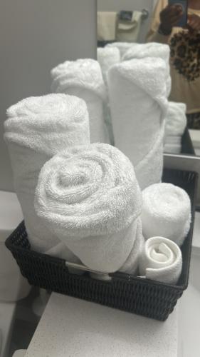 a basket filled with towels and toilet paper at Slice Of Paradise in Calgary