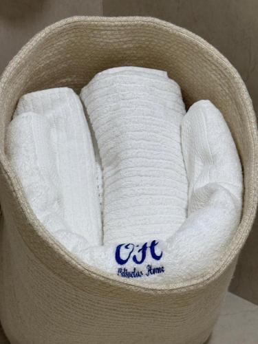a basket filled with white towels on a table at Odivelas Place 1 in Odivelas