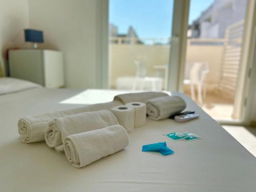 a group of towels on a table in a room at Sea Rooms - Torre Pali in Torre Pali