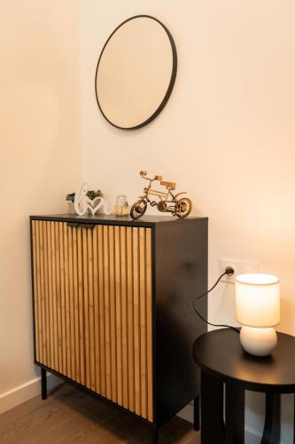 a mirror above a dresser with a bike on it at Yassam -Le Studio 301 in Saint-Brieuc