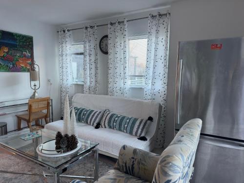 a living room with a couch and a table at One bedroom with modern kitchen, balcony with water view in Greenwich