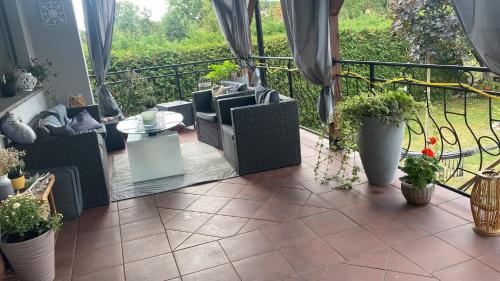 a balcony with chairs and a table and plants at Chromiczówka in Chojna