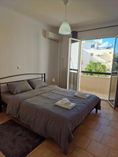 a bedroom with a bed with two towels on it at Dimitras Apartment with 3 bedrooms Elefsis in Eleusis