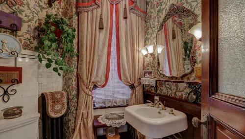 a bathroom with a sink and a mirror at Schuster Mansion Bed & Breakfast in Milwaukee