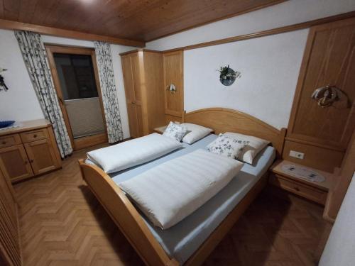 a bedroom with a large bed in a room at Gästehaus Gapp in Wildermieming