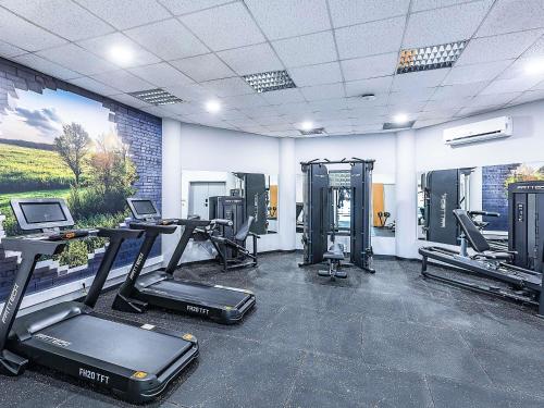 a gym with treadmills and cardio equipment in a room at Hotel ibis Evora in Évora