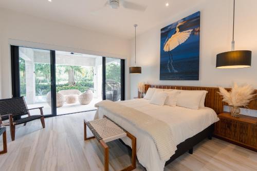 a bedroom with a large bed and a large window at Villa De Vida Luxury Accomodations in Tangolunda