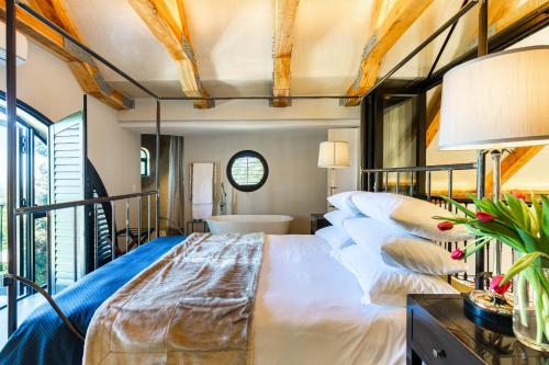 a bedroom with a large bed and a window at Devon Castle Forest Lodge in Stellenbosch
