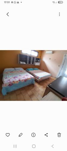 a room with two beds and a laptop on the floor at Alto Astral in Fortaleza