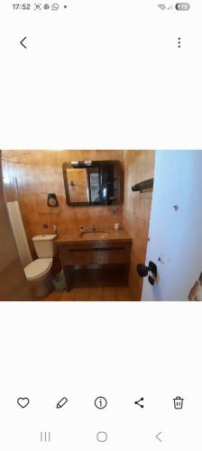 a bathroom with a toilet and a sink at Alto Astral in Fortaleza