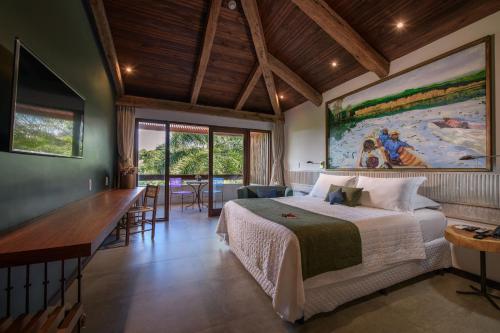 a bedroom with a bed and a large painting on the wall at Hotel Canto das Águas - Roteiro de Charme in Lençóis