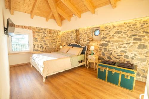 ein Schlafzimmer mit einem Bett und einer Steinwand in der Unterkunft Cà Bianca in Erba