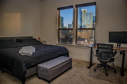 a bedroom with a bed and a desk with a computer at Downtown views by the Lake in Austin