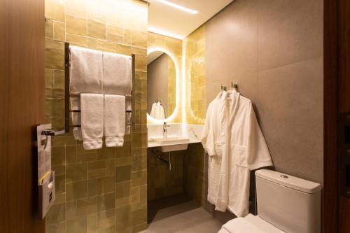 a bathroom with a sink and a toilet at Livramento Palace Hotel in Vitória da Conquista