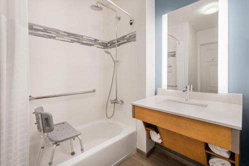 a bathroom with a sink and a tub and a shower at EVEN Hotel Miami - Airport by IHG in Miami