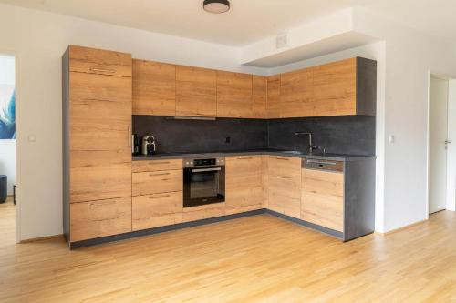 a kitchen with wooden cabinets and a counter top at Apartment be blue in Mieming