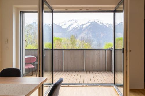 a room with a balcony with a view of mountains at Apartment be blue in Mieming
