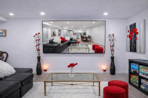 a living room with a couch and a mirror at New 2BR Suite, Walk to Dining, Near Downtown in Calgary