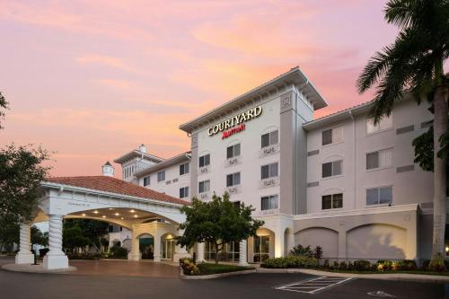a rendering of the exterior of a hotel at Courtyard Fort Myers at I-75 and Gulf Coast Town Center in Estero