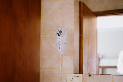 a hair dryer is hanging on a wall at Río Hotel in Colorado River