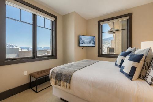 a bedroom with a large bed and two windows at Tranquil Blackstone Getaway in Park City