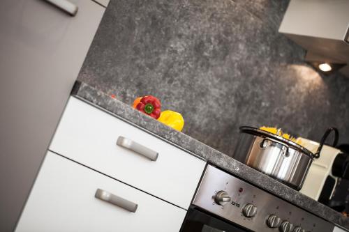 a kitchen counter with a stove with a pot on it at Art-Apartments Kartnaller superior in Neustift im Stubaital
