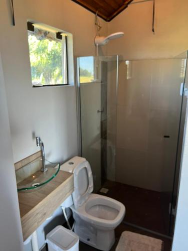 a bathroom with a toilet and a sink and a shower at Pousada Bonetti Quarto 4 in Santa Rosa