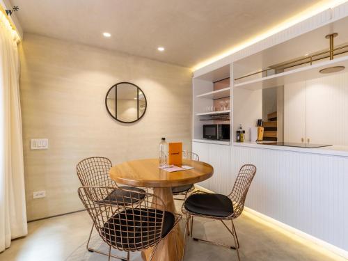 a kitchen and dining room with a wooden table and chairs at Palace by Wynwood House in Bogotá