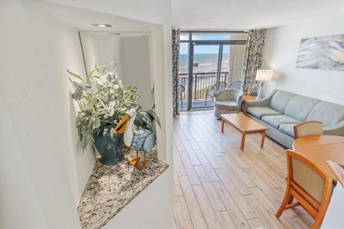 a living room with a couch and a table at New Remodeled Direct Oceanfront Views Beach Cove in Myrtle Beach