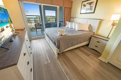 a hotel room with a bed and a balcony at 2BR Pools, Direct Oceanfront Views, Handicap, Nice in Myrtle Beach