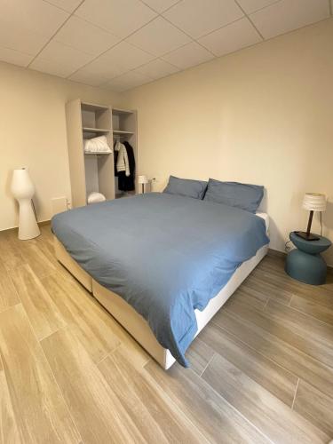 a bedroom with a large bed and a wooden floor at Mama Lidia in Creazzo