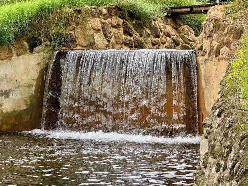a waterfall on the side of a river at Fazenda Vale Dourado in Nova Friburgo